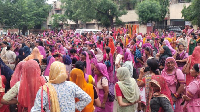 Female Anganwadi workers staged a sit-in protest