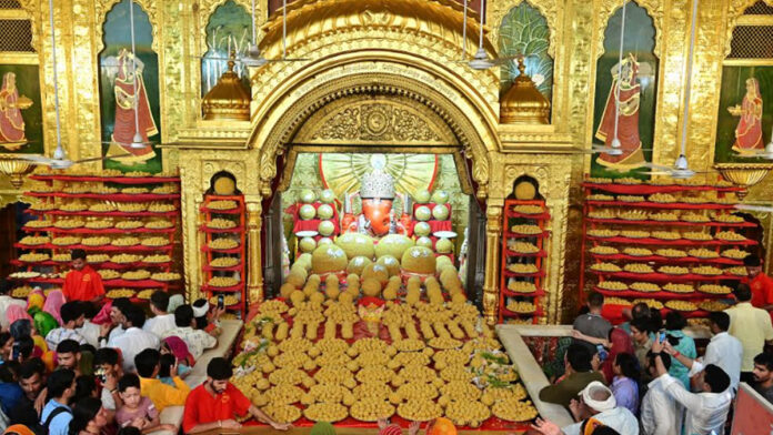 A tableau of modakas decorated in front of the first worshipped Ganesha